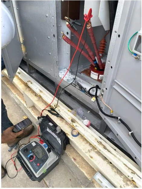 Technician testing electrical equipment on site